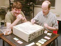 [Picture of two people 
playing a board game on top of a computer]