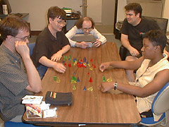 [Picture of a pyramidal pieces 
and puzzled players]